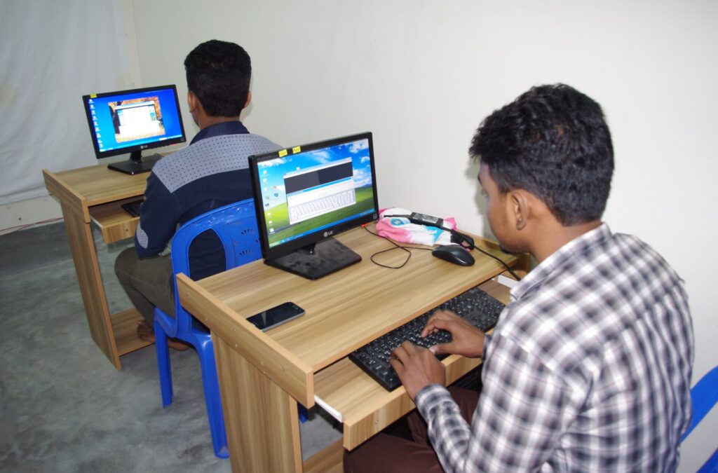 two young boys with a computer
